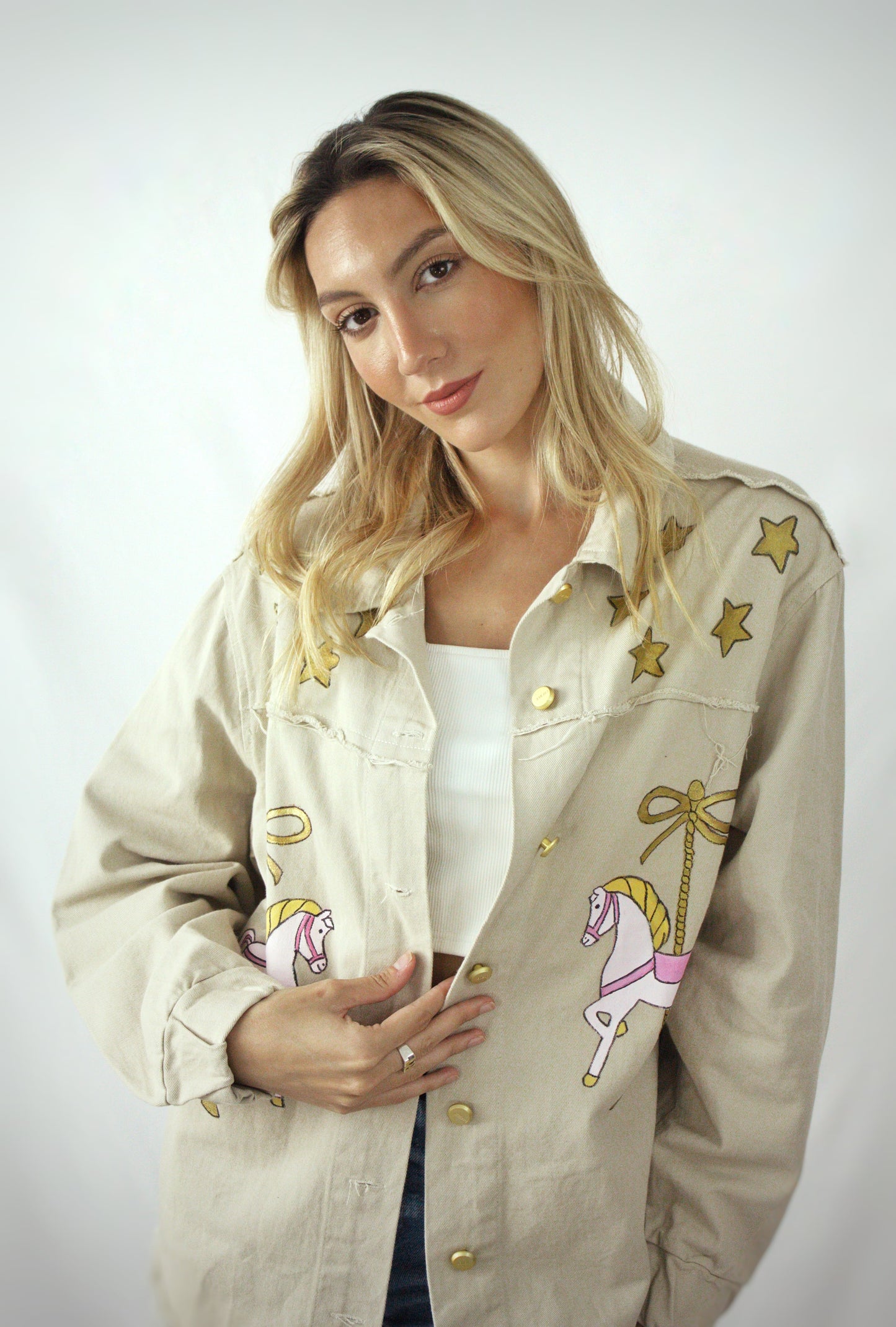 Hand-painted oversized gabardine jacket with carousel horse design in pink, gold, and white for women