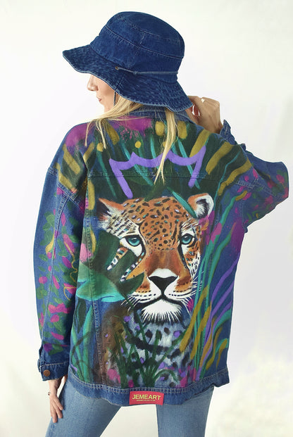 Hand-painted oversized denim jacket for women featuring a crowned leopard and tropical leaves in vibrant colors.